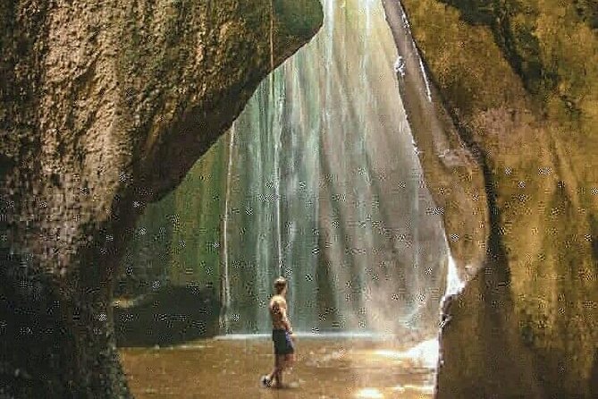 Bali best waterfall - Tukad Cepung Waterfall: light through cliff-framed water