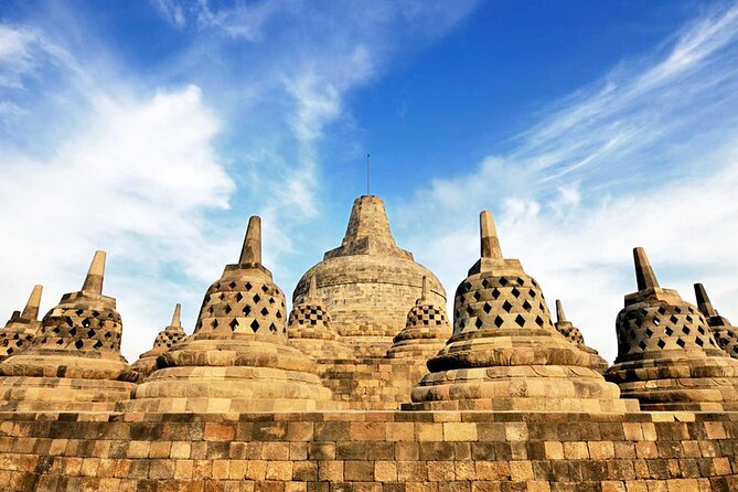 Yogyakarta: Borobudur Climb-up & Prambanan Day Trip All Inclusive - The Borobudur climb-up: statues, spires, and summit views